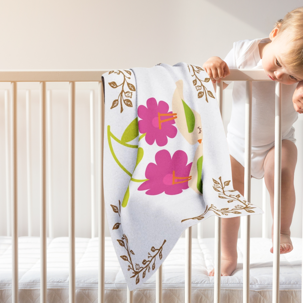 birds and flowers baby blanket shown in nursery setting