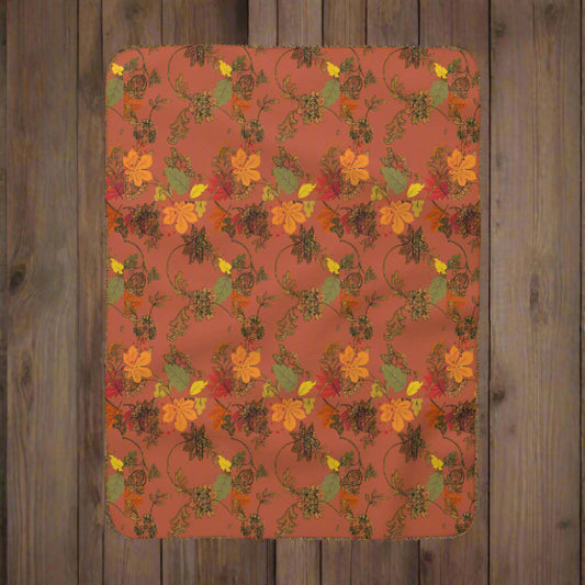 Floral patterned blanket with autumn colors on a red background