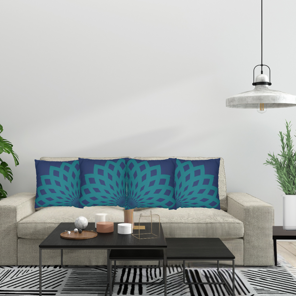 Dark blue throw pillow with large teal floral mandela pattern shown with four pillows on a couch