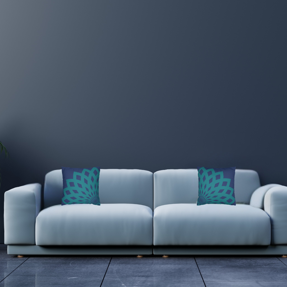 Dark blue throw pillow with large teal floral mandela pattern in a light blue living room