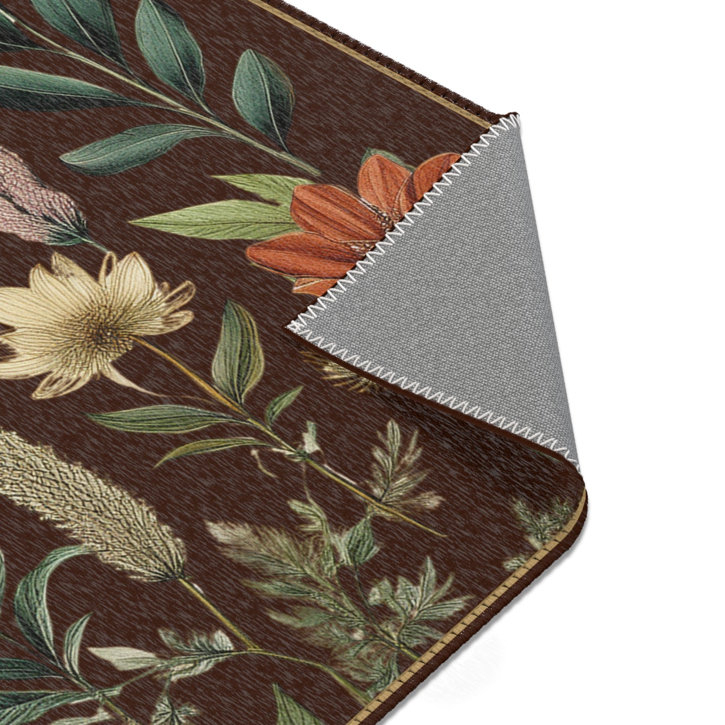 Close-up of floral-patterned rug with a contrasting gray backing underneath.