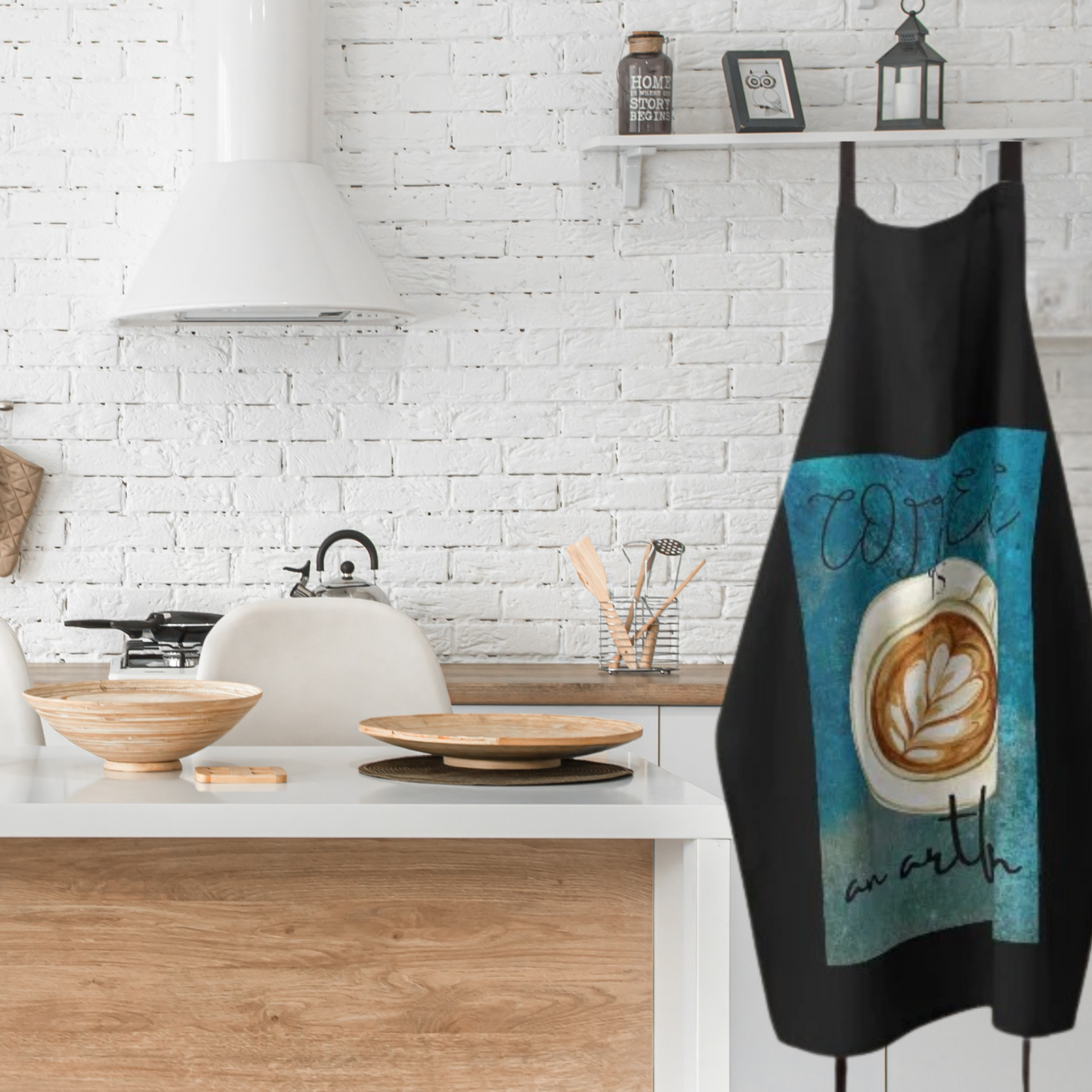 black and teal apron with decorative cup of coffee hanging in a white farmhouse style kitchen