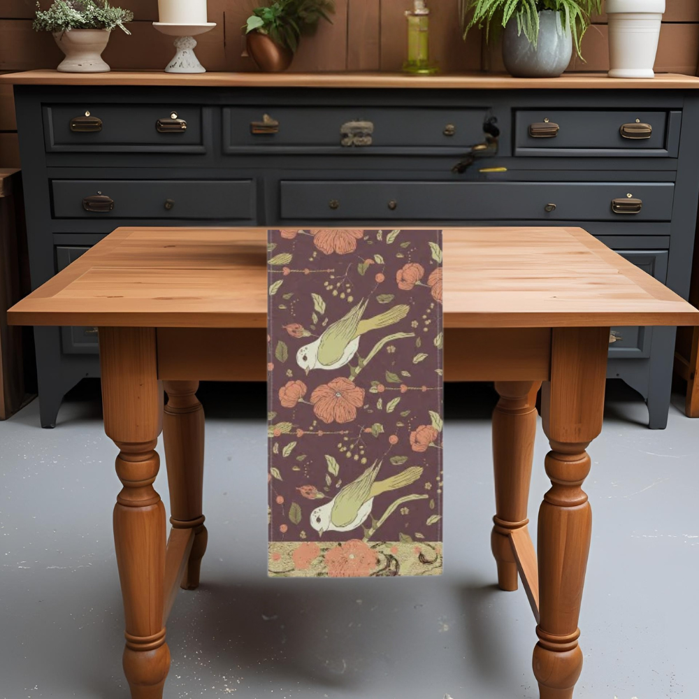Table runner with birds and flowers in rich autumn tones shown on a table in a kitchen