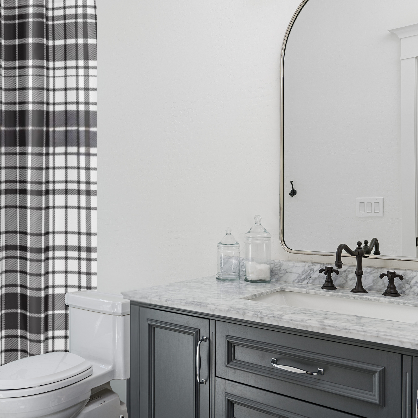 Shown in a modern bathroom with white marble counters
