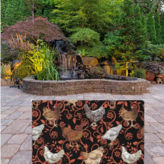 Adorable outdoor rug with a floral pattern and chickens shown on a brick patio