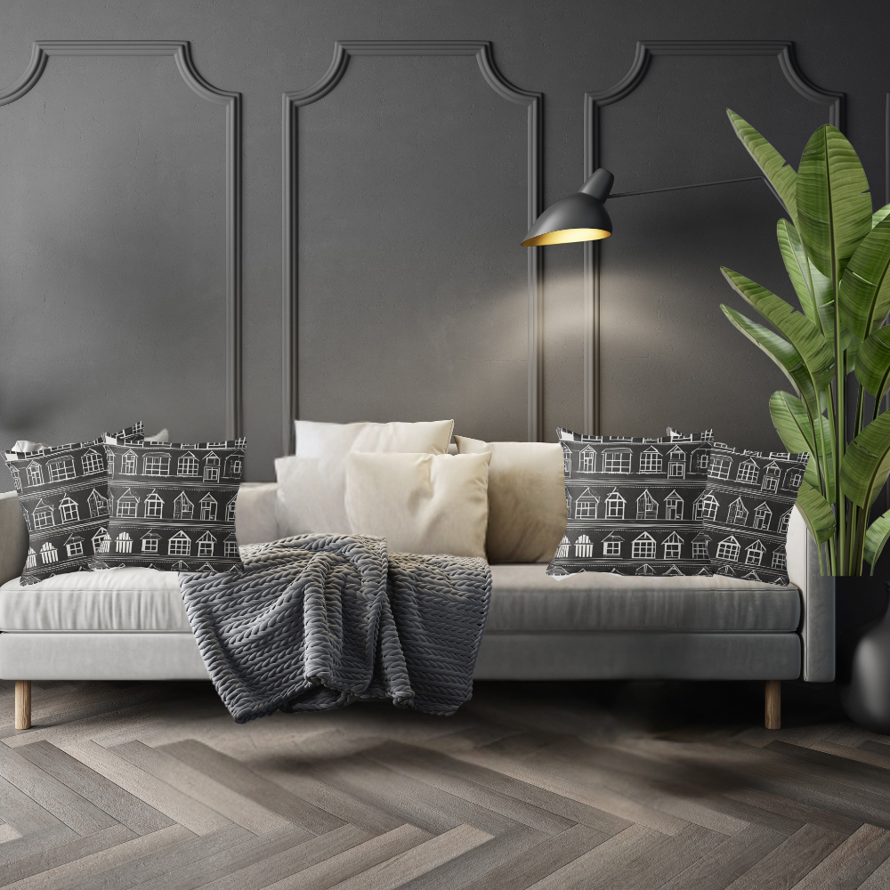 Luxe living room with a white sofa and decorative Home Sweet Home pillows, and a plant against a dark paneled wall.