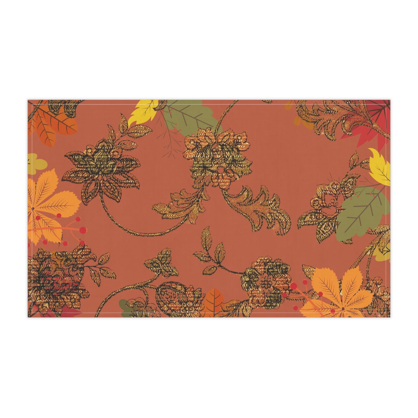 Deep orange background with bronze floral pattern and multi colored fall leaves on a kitchen tea towel