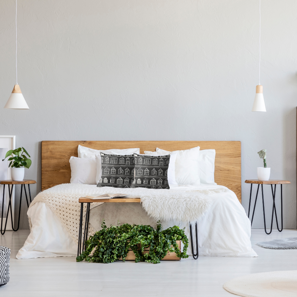 Modern farmhouse style bedroom with wooden bed, white bedding, and Home Sweet Home accent pillows