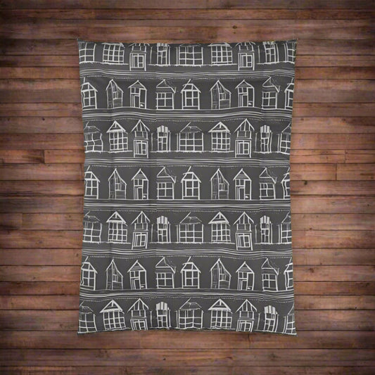 Closeup of Home Sweet Home Comforter with white house pattern on a black background