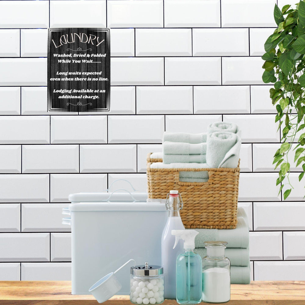 Laundry Room Decor wall art print shown in Black aga inst a white tile wall