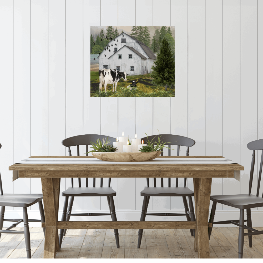 modern farmhouse style wall art with a nostalgic barn and cows shown in a modern farmhouse style dining room