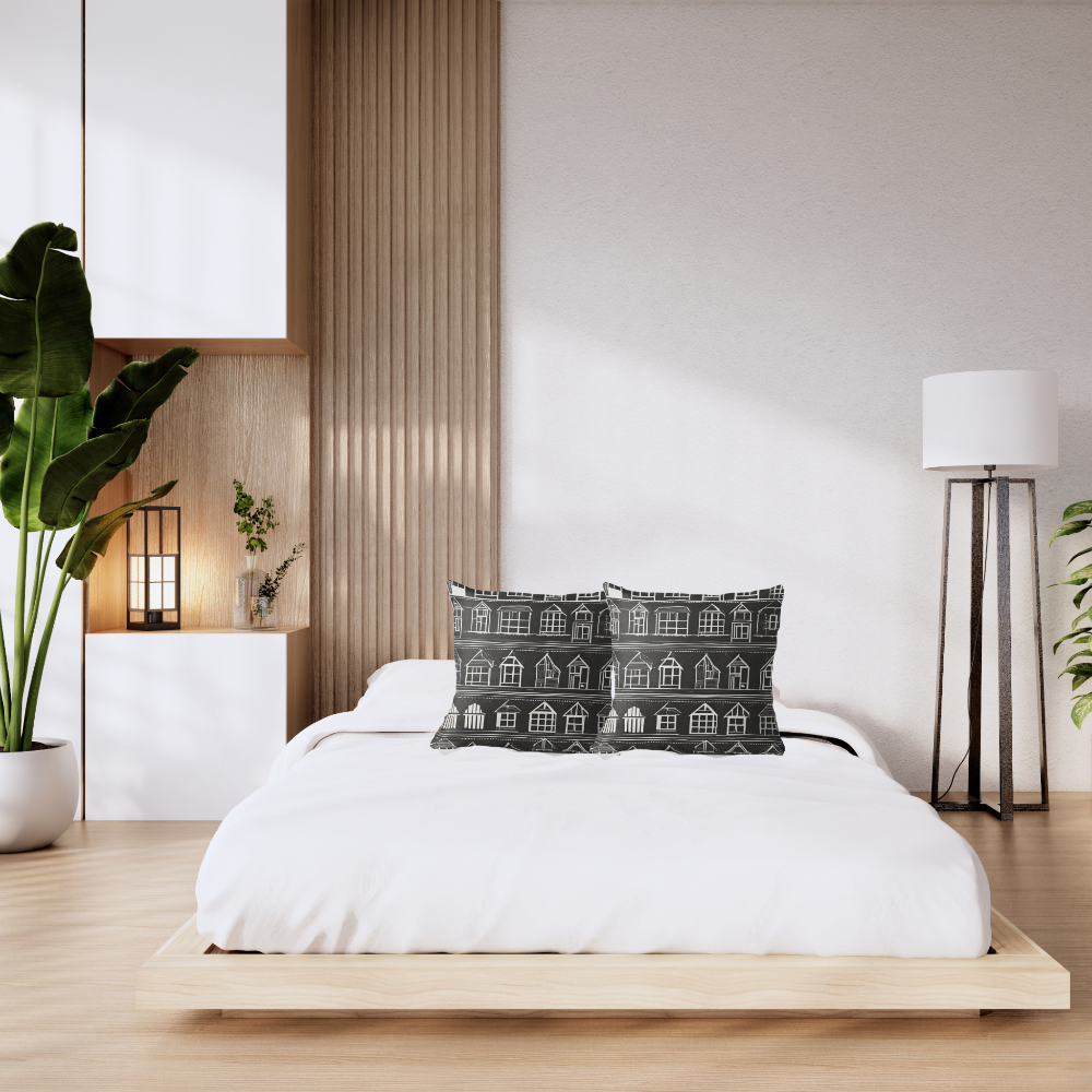 Modern bedroom with a bed, our Home Sweet Home decorative pillow, and plants.