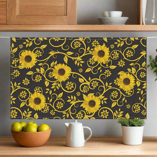 Floral pattern with yellow sunflowers on a black background shown with kitchen items