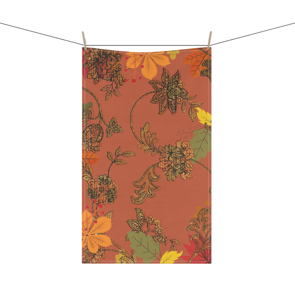 Fall floral patterned towel hanging on a line with a white background
