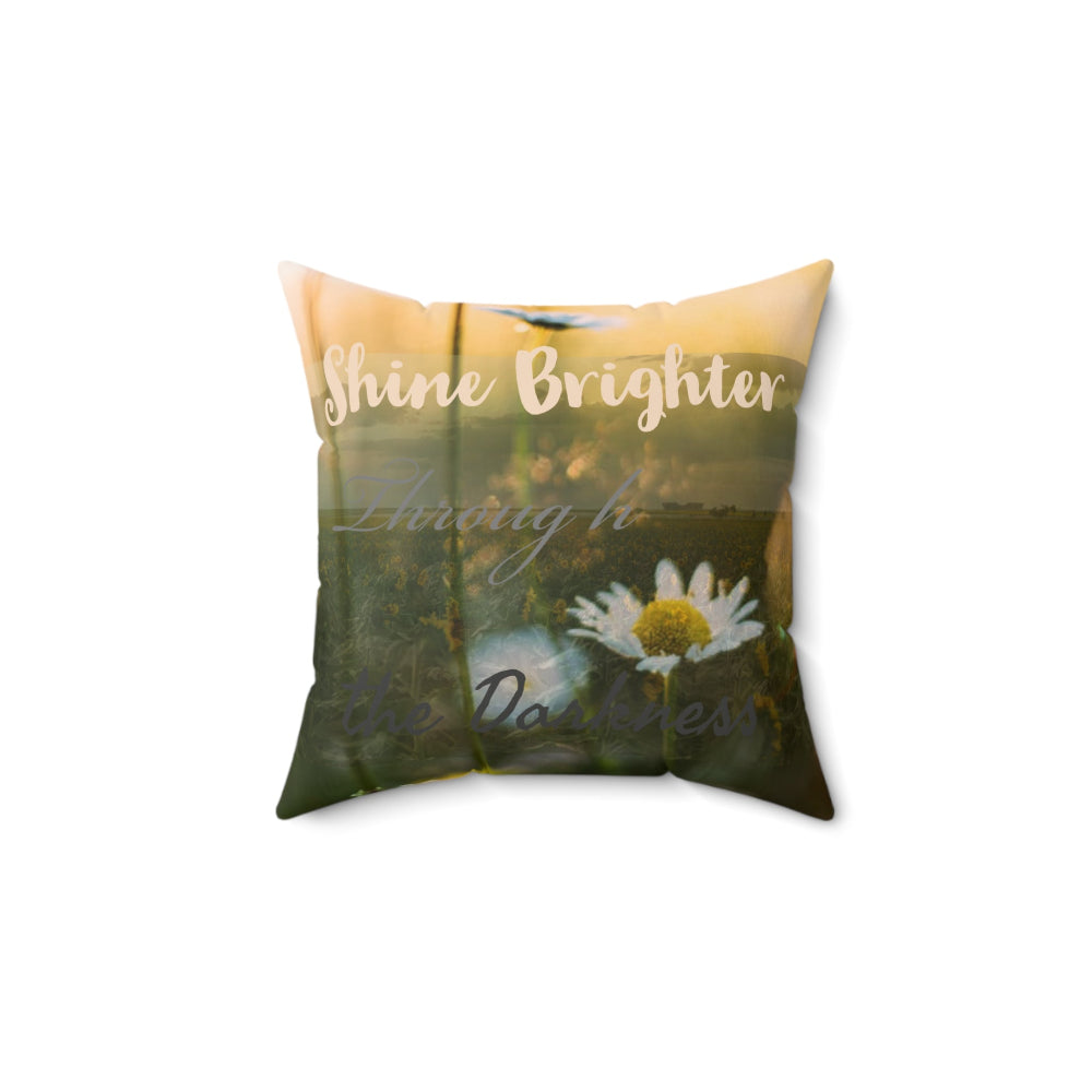 Decorative pillow with nature-themed design and inspirational Shine Brighter Through the Darkness text shown on a white background