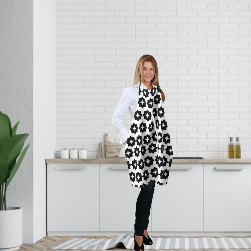Photo features a  woman standing in a kitchen wearing a black and white farmhouse style graphic
