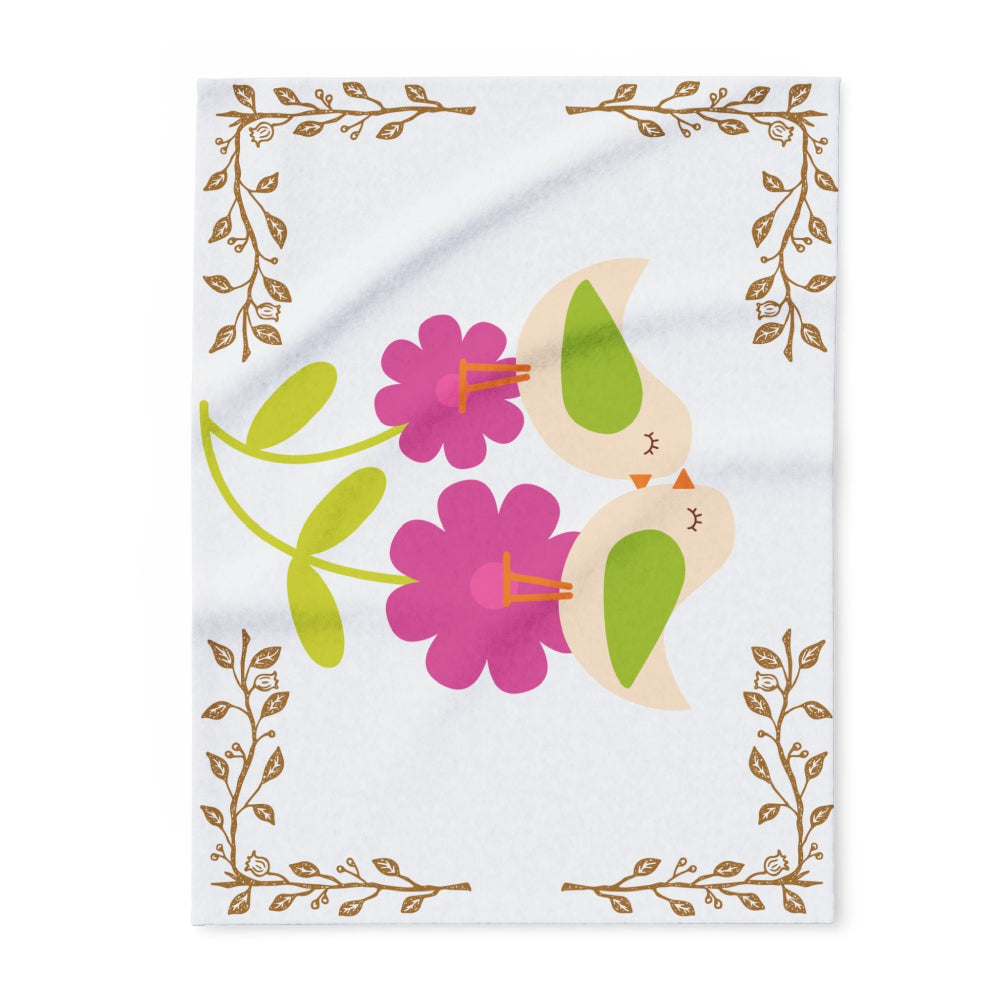 Detail of a cozy white fleece baby blanket adorned with delicate birds and bright blooming florals