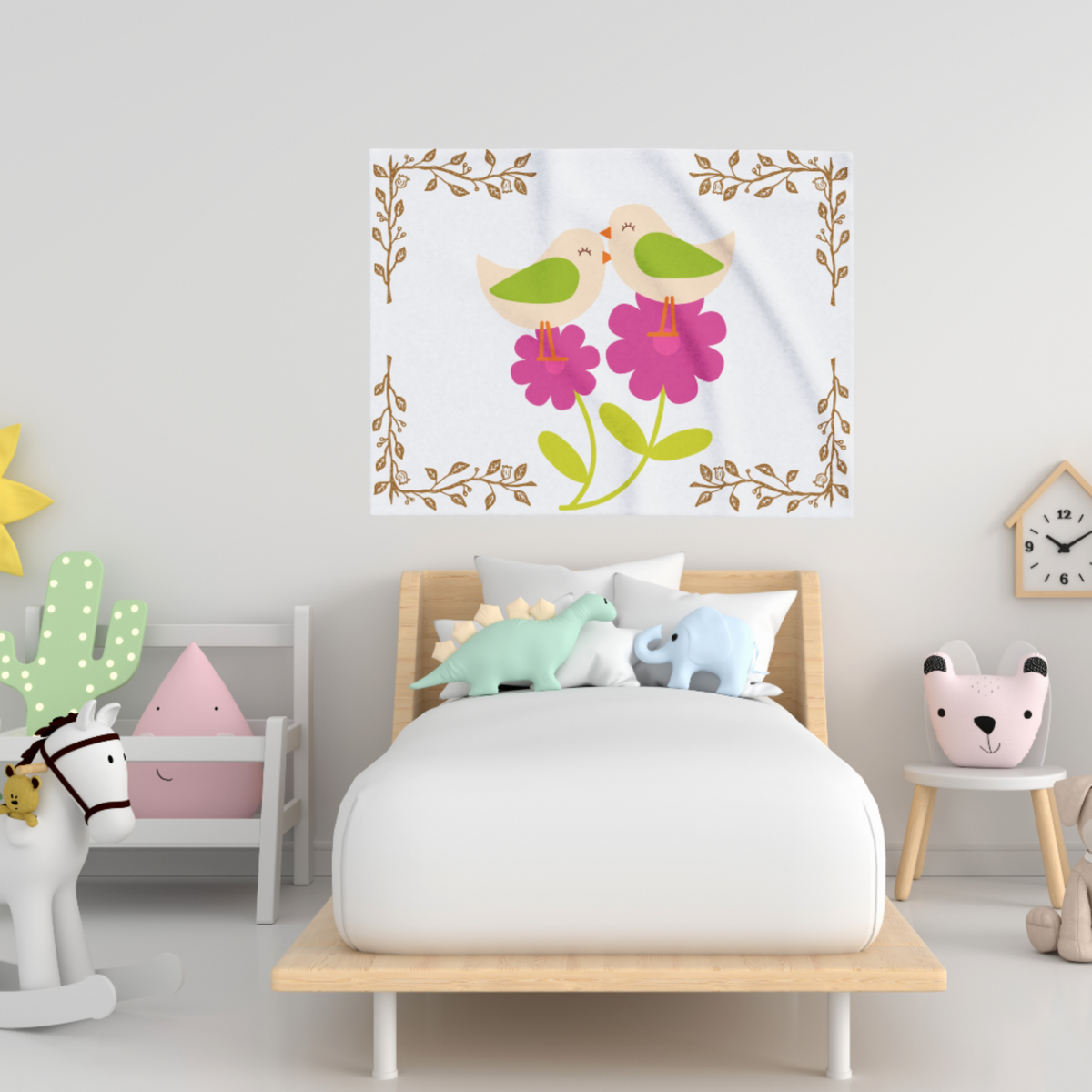 Soft fleece baby blanket featuring a whimsical birds‑and‑blossoms pattern in gentle floral tones, shown as wall decor in a girls bedroom.