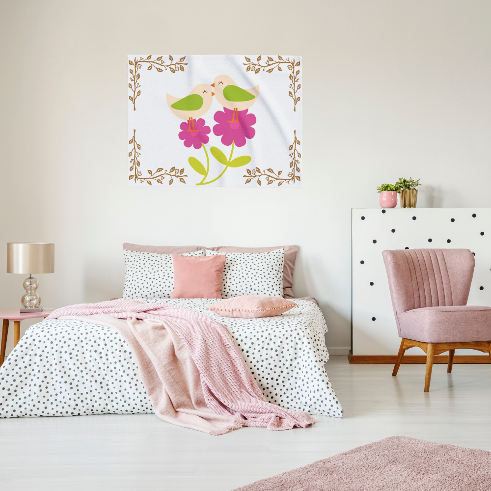 Birds and Blossoms baby blanket — lightweight polyester fleece with pink floral and woodland bird design, shown on a wall in a young girls bedroom.