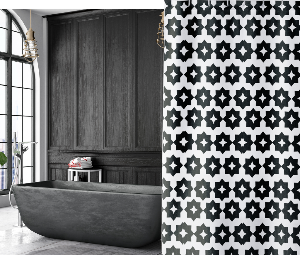 black and white geometric shower curtain in a moody dark bathroom