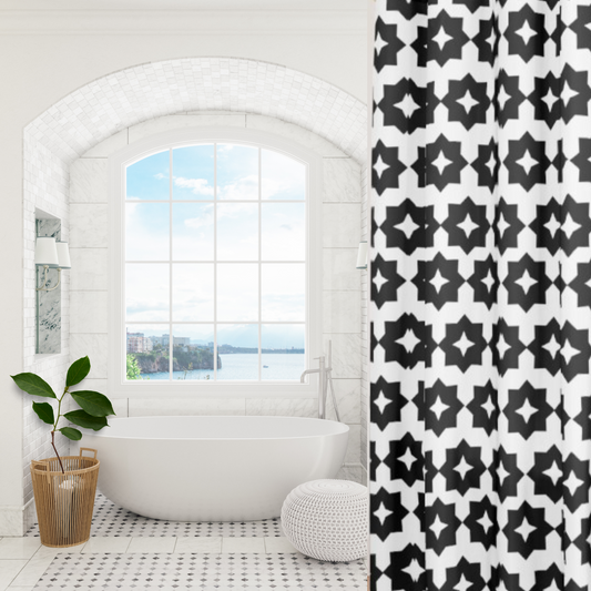 A black and white geometric patterned shower curtain shown in an elegant bathroom