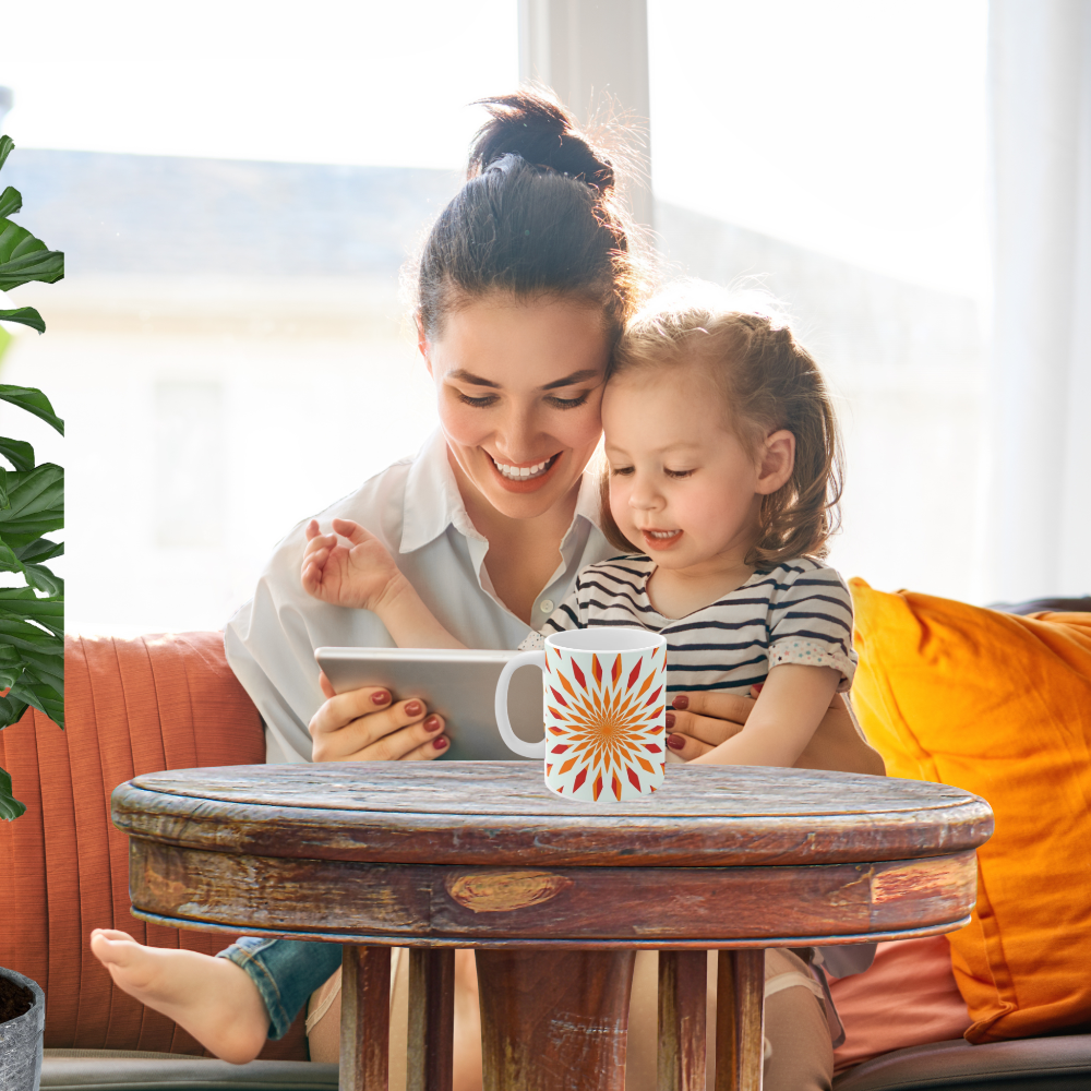 orange starburst mug shown in a bright room with a woman reading to a child