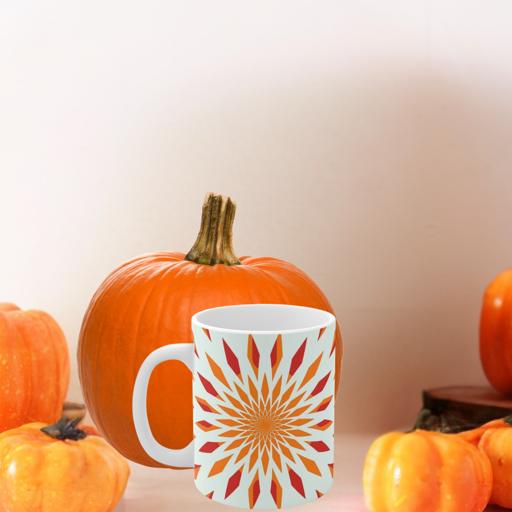 orange starburst mug shown with pumpkins on a kitchen countertop