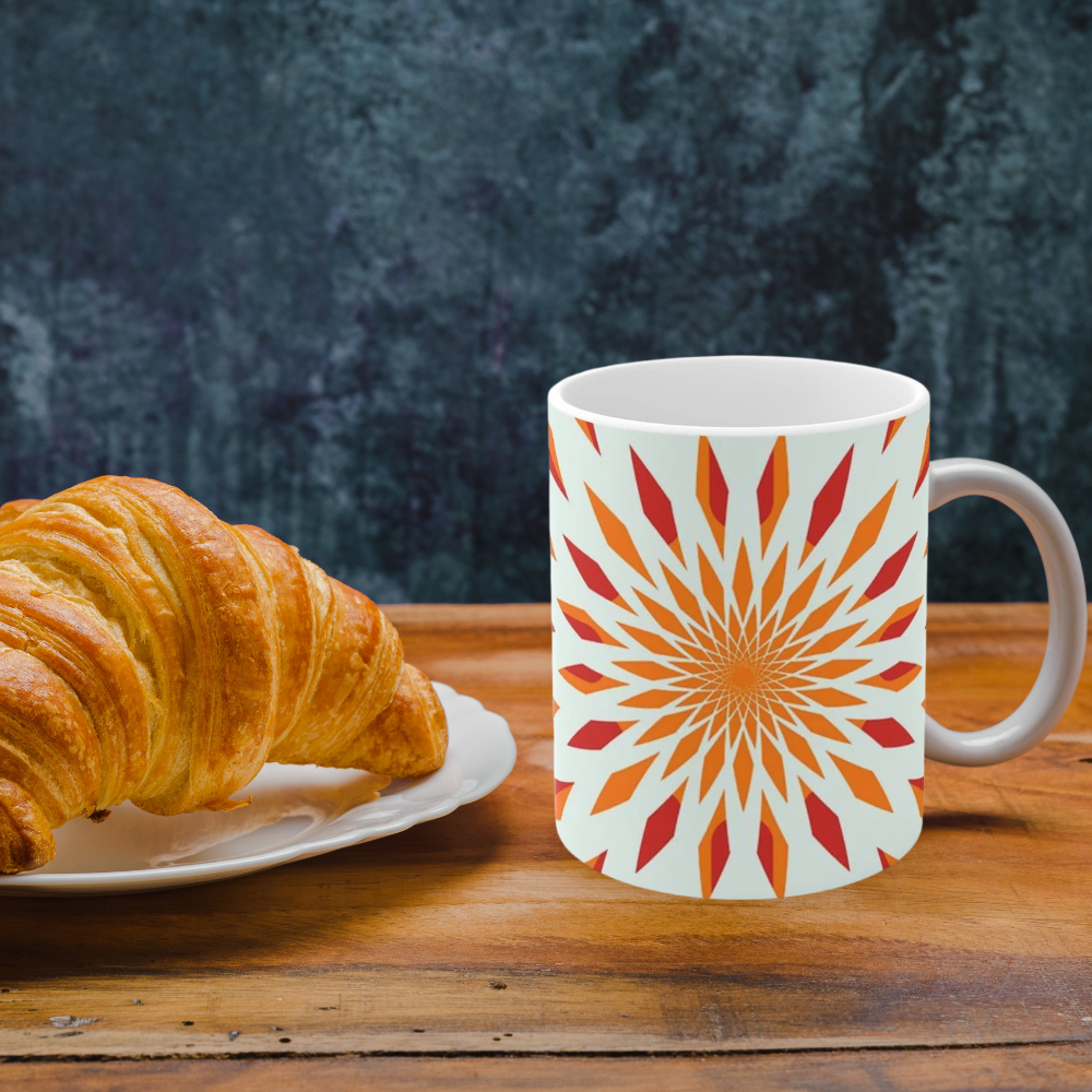 orange starburst mug shown in a kitchen with a croissant