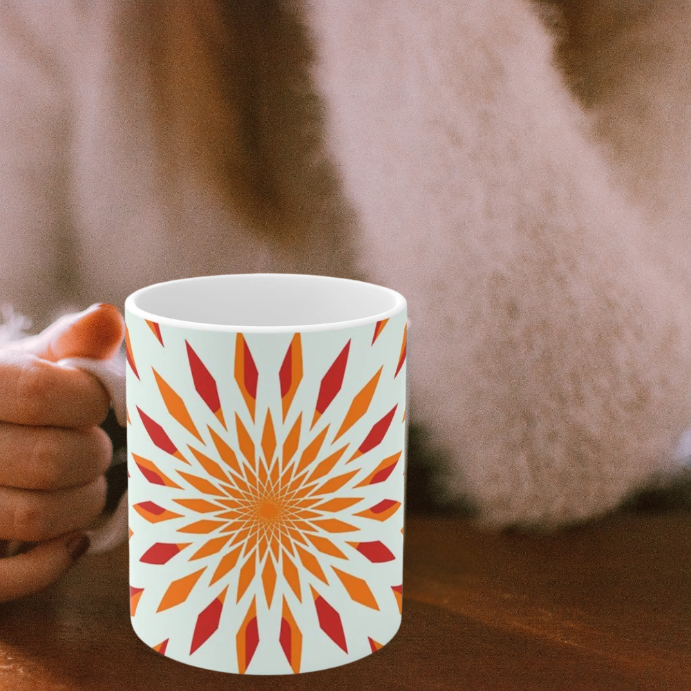 orange starburst mug shown on a table with a woman holding its handle