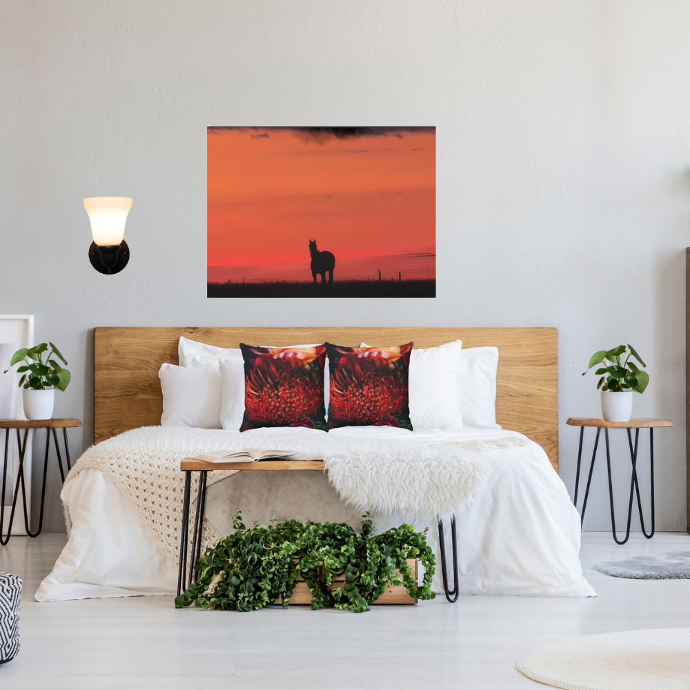 Silhouette of a horse at sunset shown in a modern, comfy bedroom