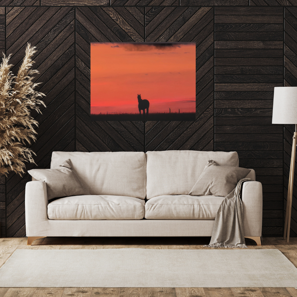 Silhouette of a horse at sunset shown in a den with a dark wood wall and a light colored couch