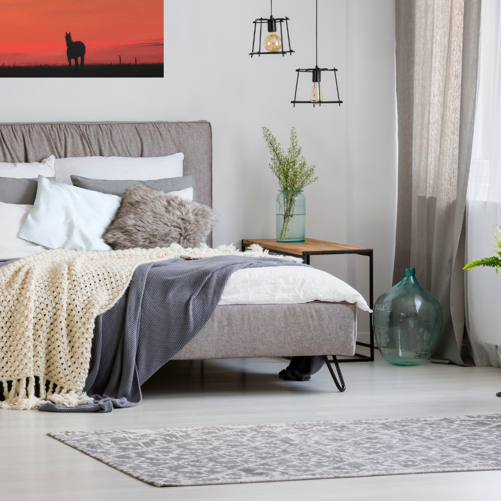 Silhouette of a horse at sunset shown in a comfy bedroom