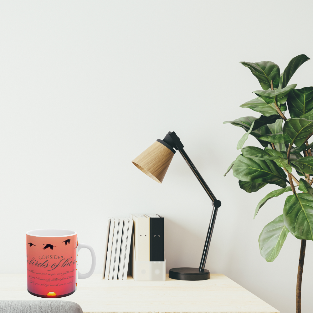 Consider the birds inspirational mug shown on a desk in a home office