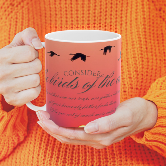 Consider the birds inspirational mug shown with a woman in an orange sweater