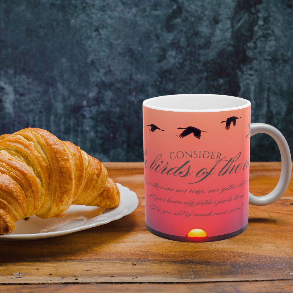 Consider the birds inspirational mug shown on a kitchen counter with a croissant