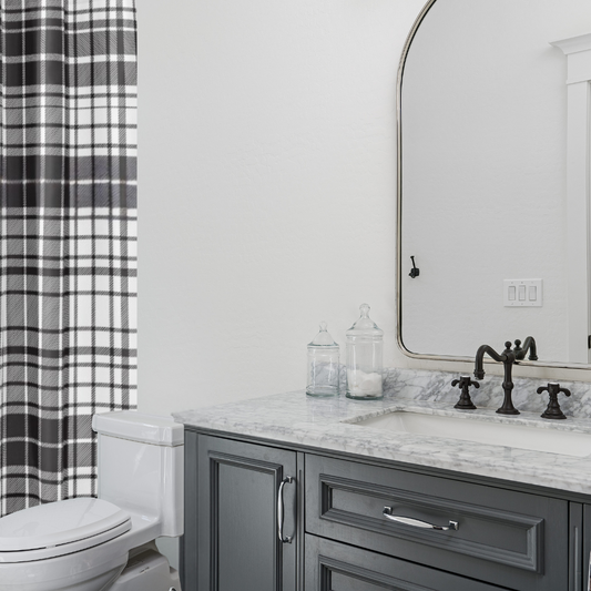 chic black and white plaid shower curtain shown in a modern bathroom with a granite countertop