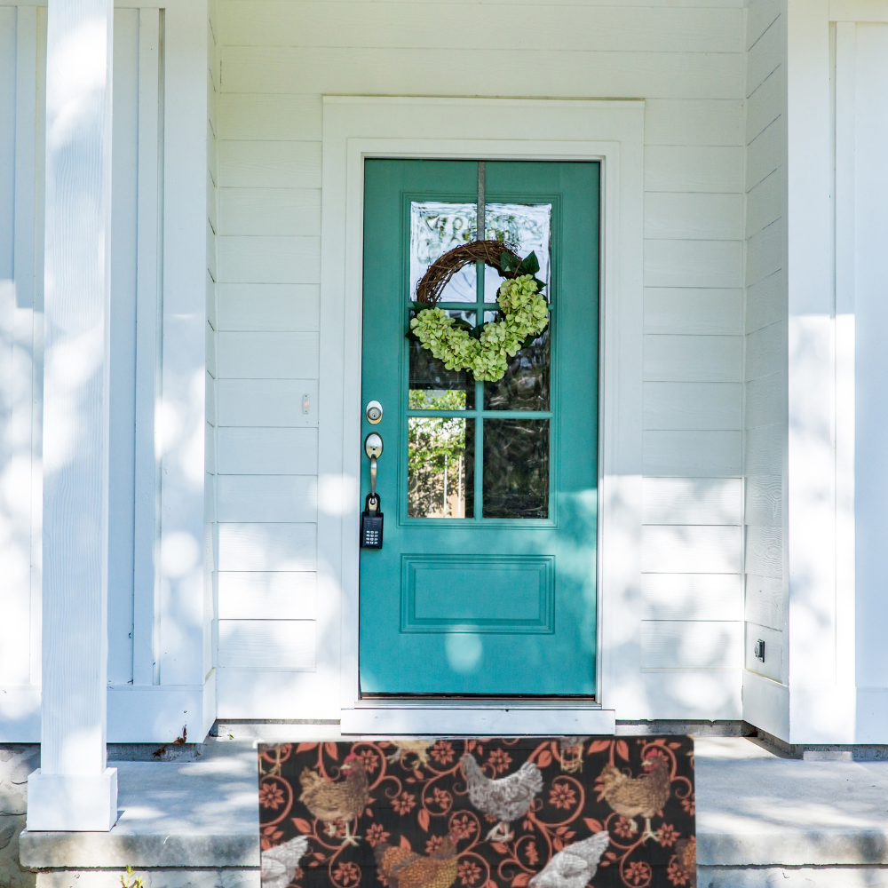 Chicken Outdoor Rug shown in front of a turquoise colored front door