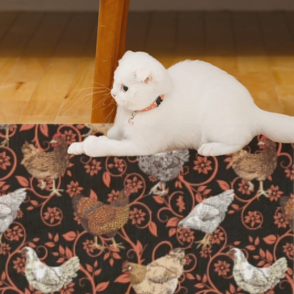 Chicken Outdoor Rug shown in a room with a fluffy white kitten laying on it