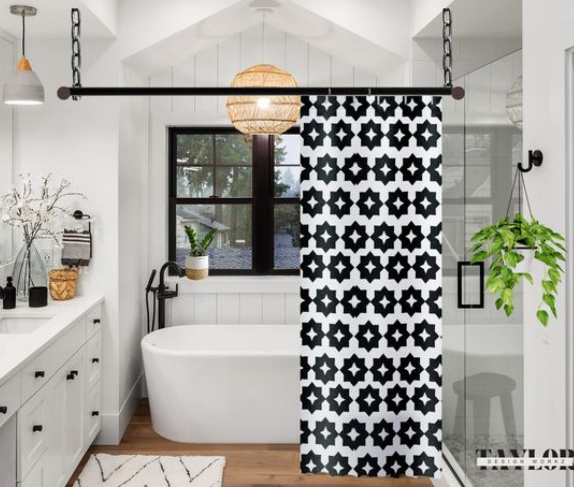 A black and white geometric patterned shower curtain shown in an elegant bathroom