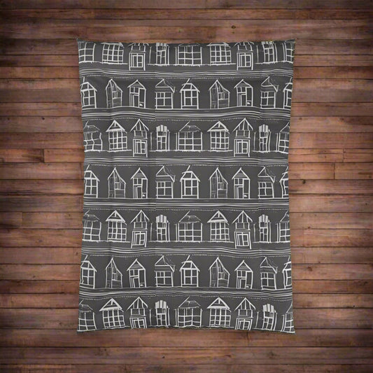 Closeup of Home Sweet Home Comforter with white house pattern on a black background