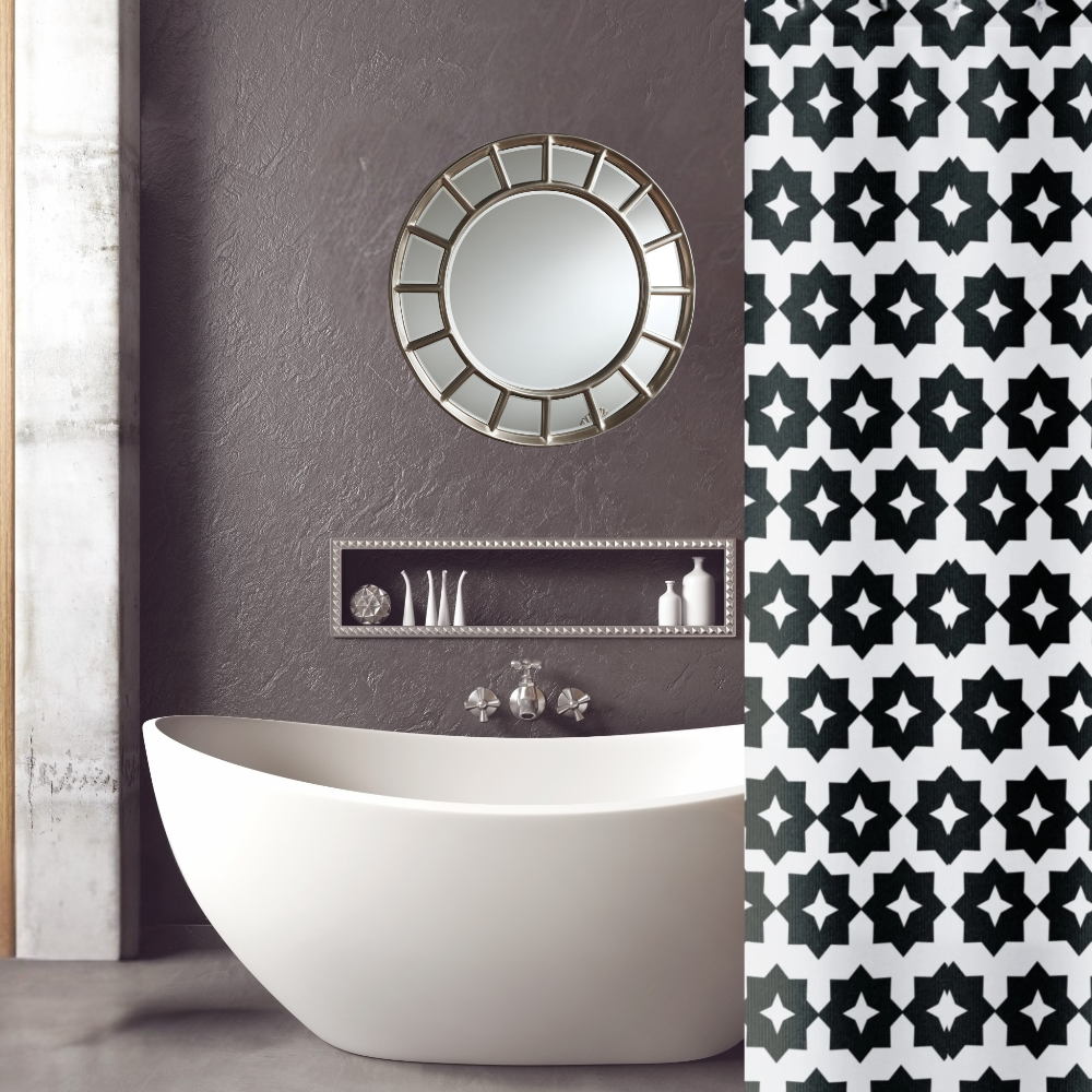 A black and white geometric shower curtain shown in a gorgeous bathroom setting