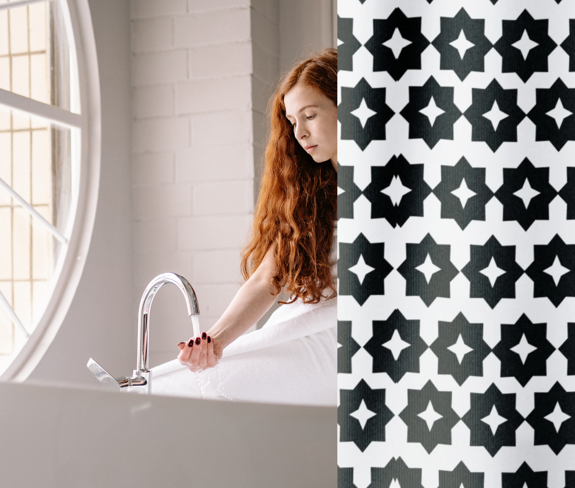 A black and white geometric patterned shower curtain shown in an elegant bathroom with a female model