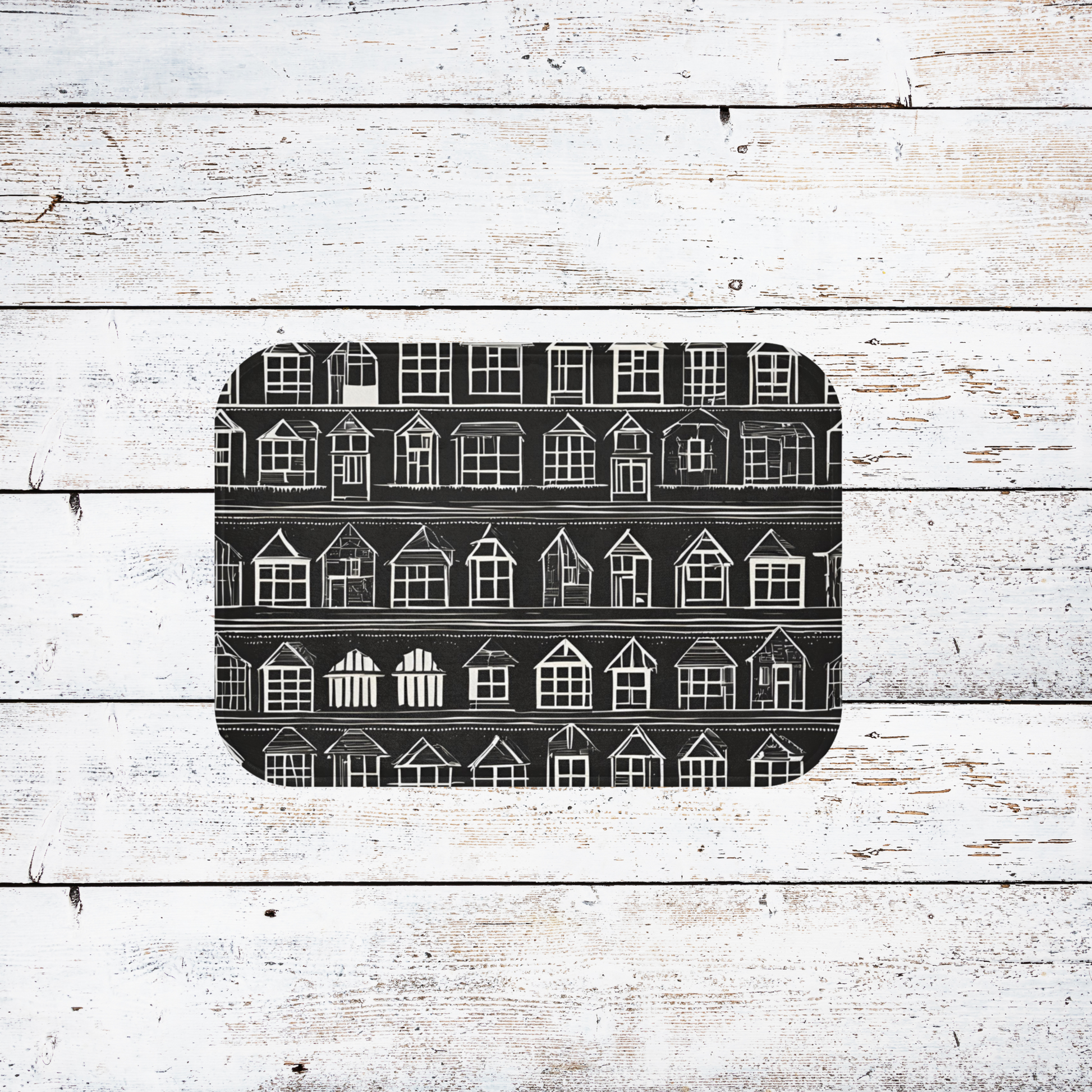 home sweet home rug featuring little white houses on a black background, shown on  a white wood floor