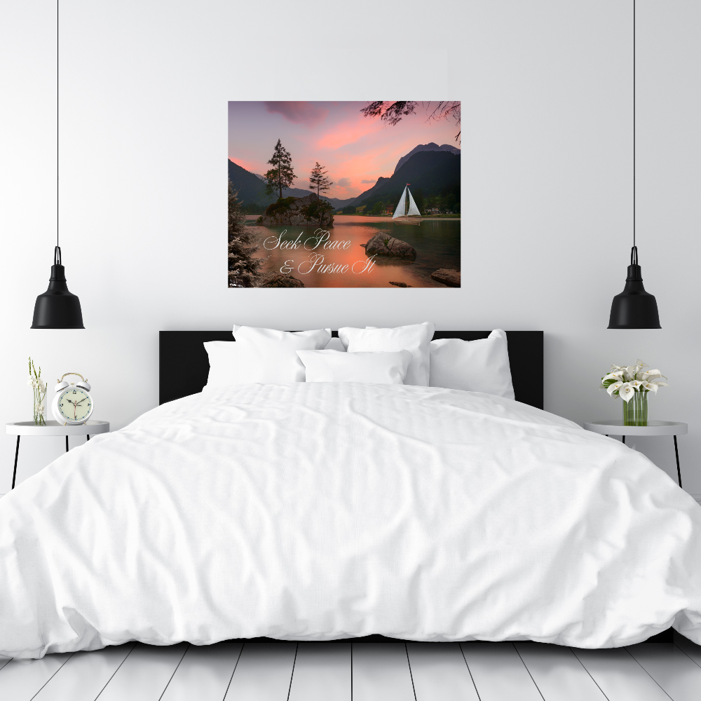 Bedroom with a large bed and a wall art print of a sunset over water with a sailboat and the text Seek Peace and Pursue It.