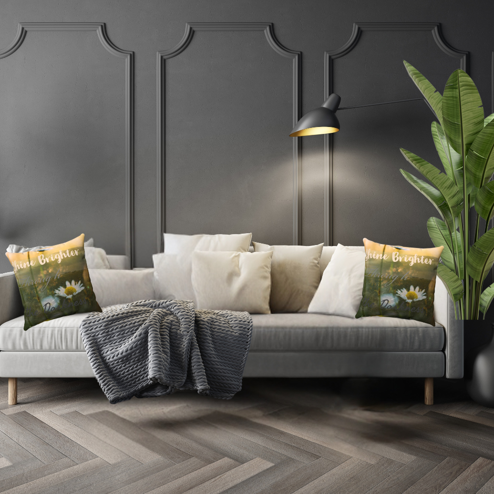 shown in a luxe living room on a grey sofa