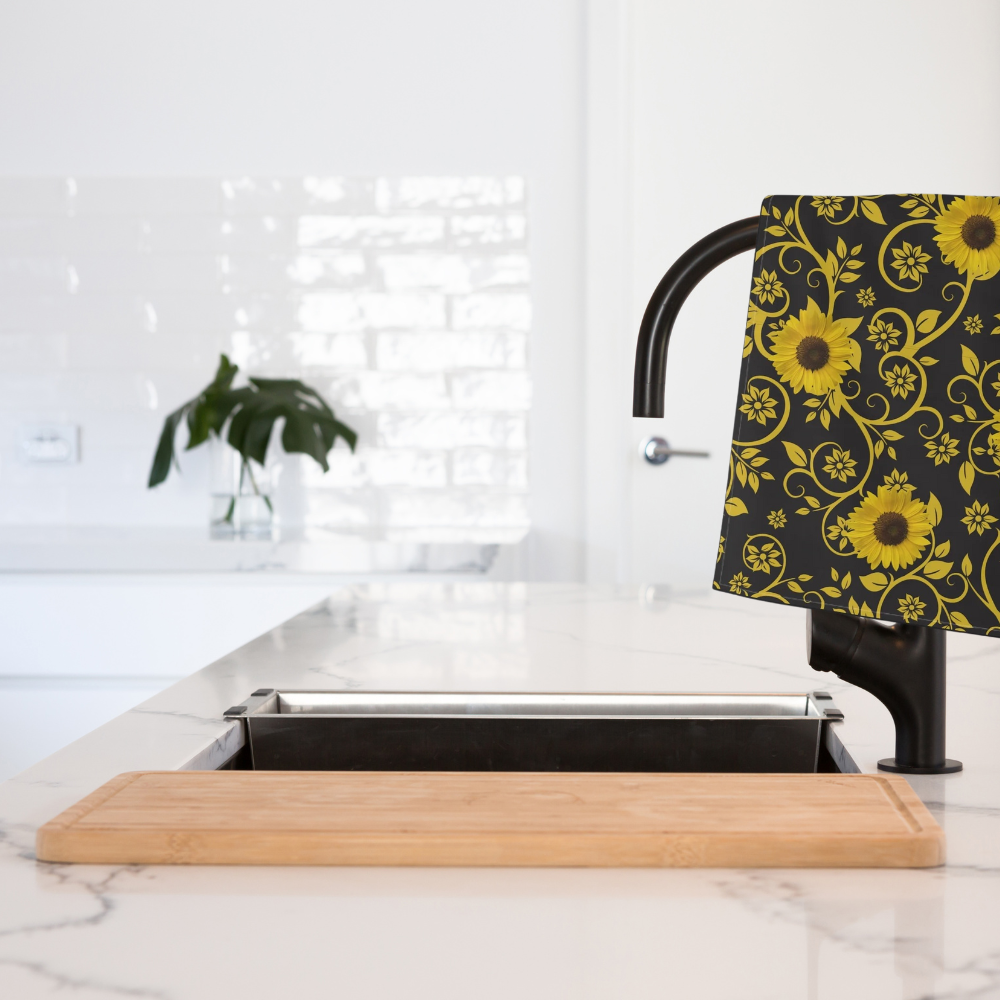 Sunflower Patterned Tea Towel shown in a kitchen draped over a black faucet