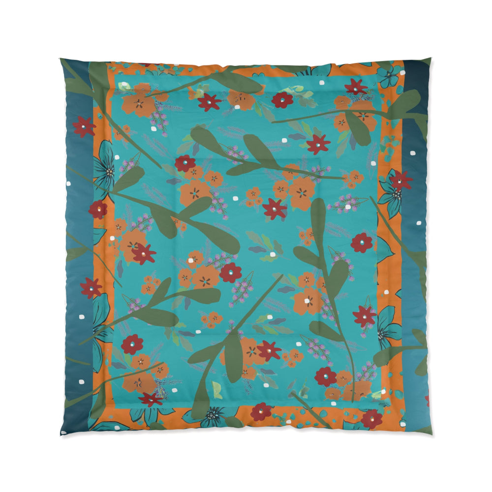 Floral patterned comforter with a teal blue background