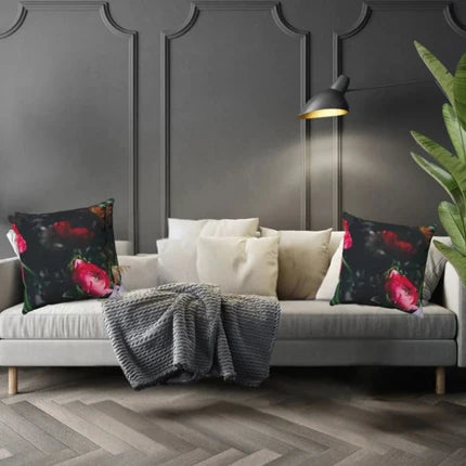 Gray sofa with floral cushions against a dark paneled wall