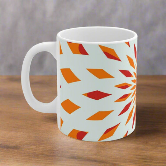 detail of orange starburst on white ceramic mug